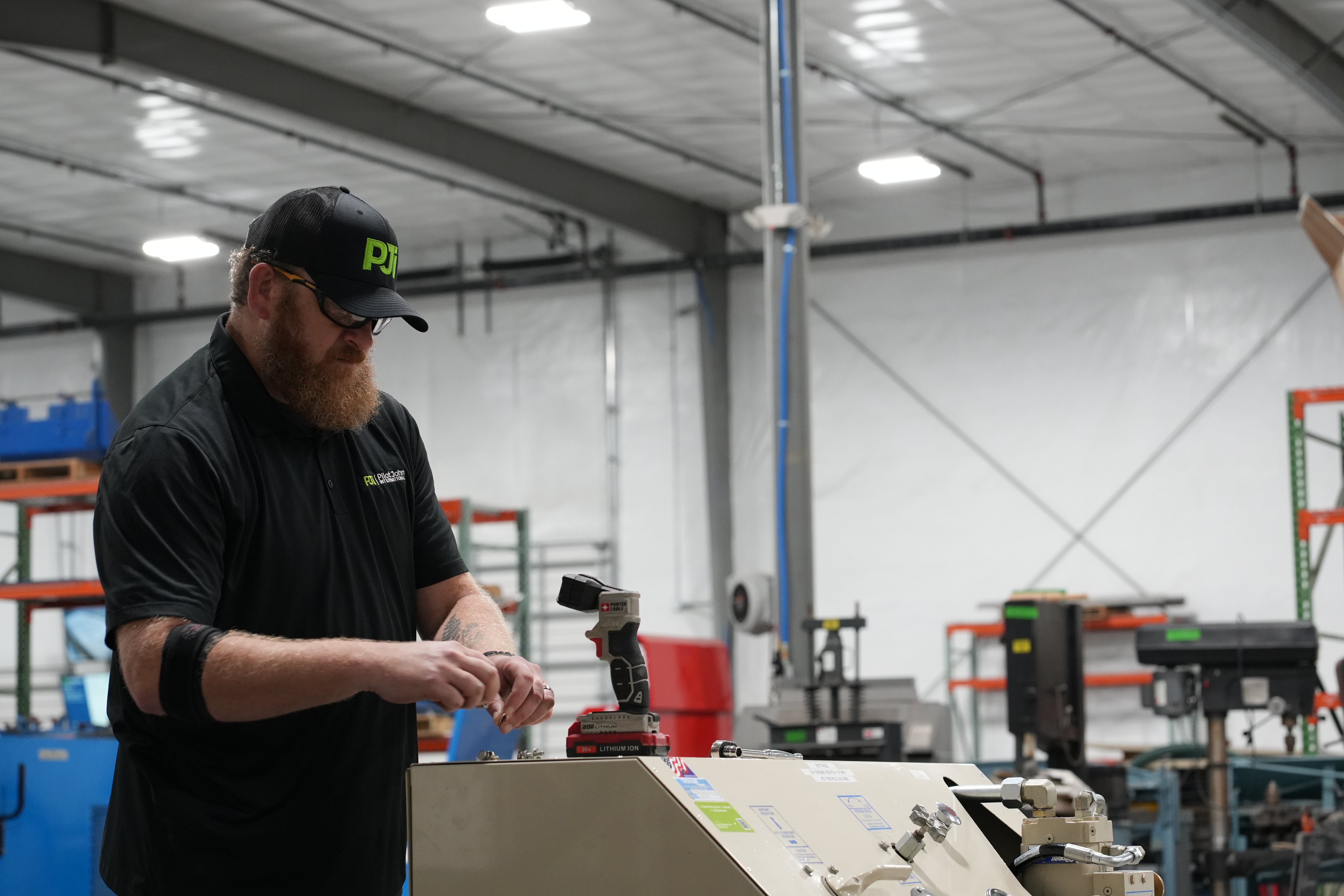 PJi&reg; Service Technician Working on a Hydraulic Power Unit (HPU)