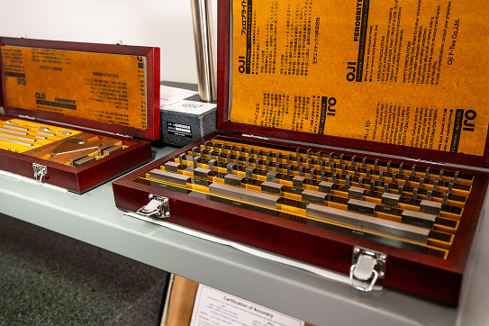 Gauge block set in a wooden case used for precision calibration and measurement standards.