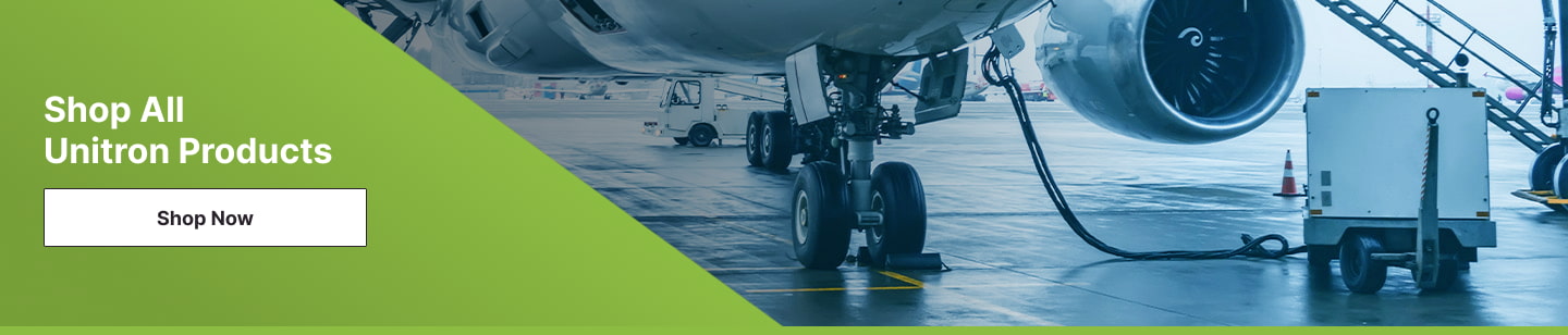 An image of a commercial aircraft on the tarmac plugged into a ground power unit.