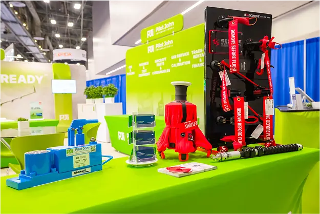Pilot John International trade show booth display featuring blue Tronair equipment, red remove-before-flight tags, and aircraft tooling solutions.