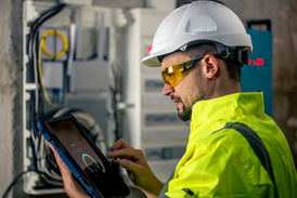 Aircraft Electrical Technician Working on a Tablet