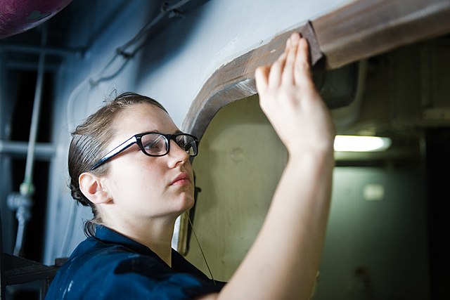 Aircraft Maintenance Technician Performs Corrosion Prevention Procedure on Aircraft