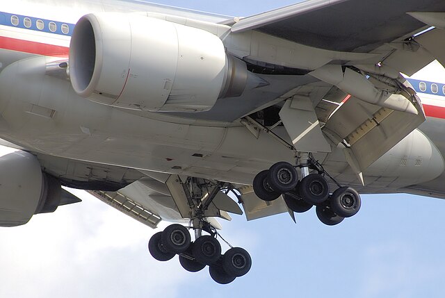  American Airlines aircraft in flight with landing gear down from below