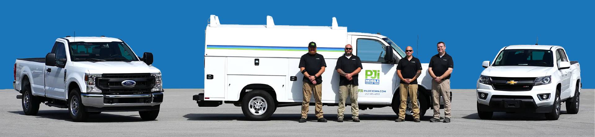 Four PJi Mobile Service Team technicians stand in front of a branded white service van, wearing black shirts and khaki pants, posing for a team photo against a blue background.