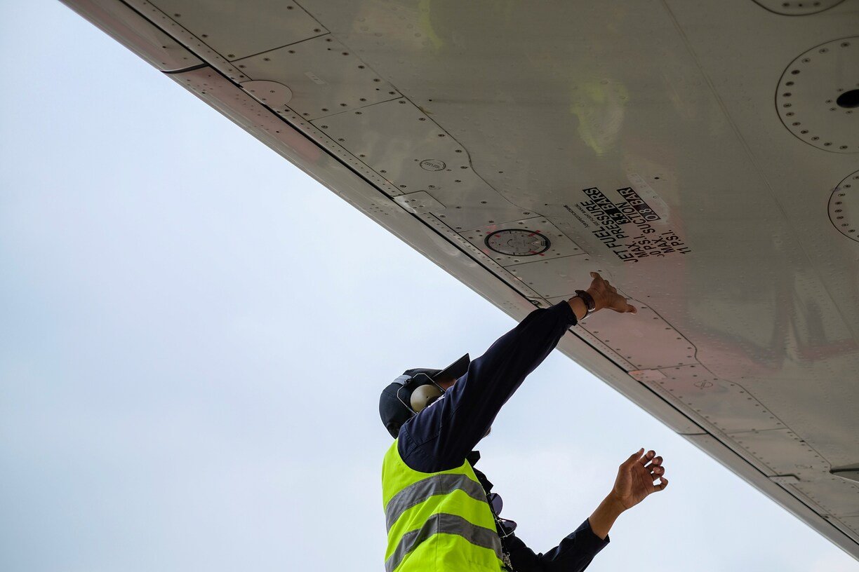 Aircraft Maintenance Technician Working on an Aircraft Wing