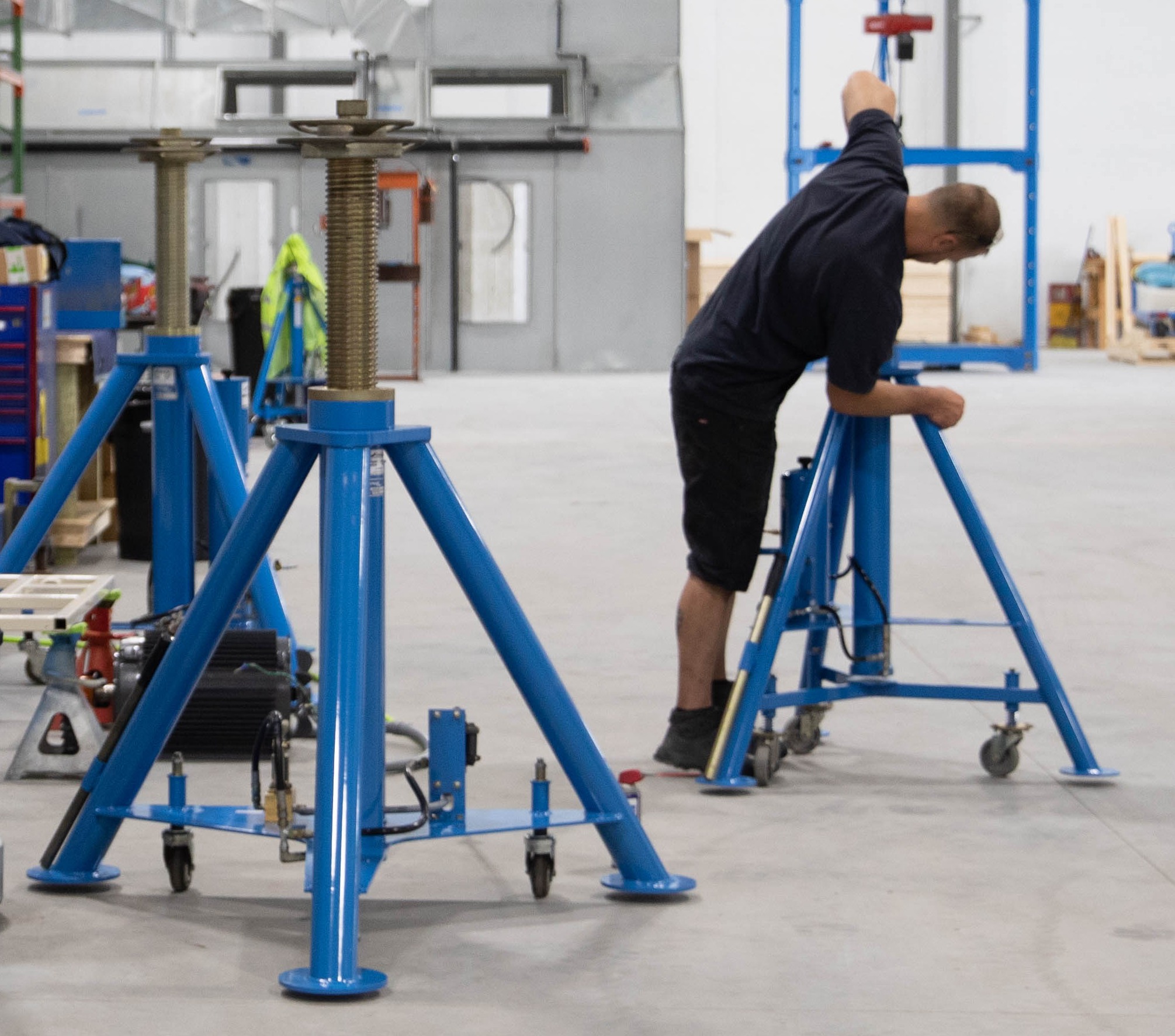 Service Technician Working on an Aircraft Tripod Jack