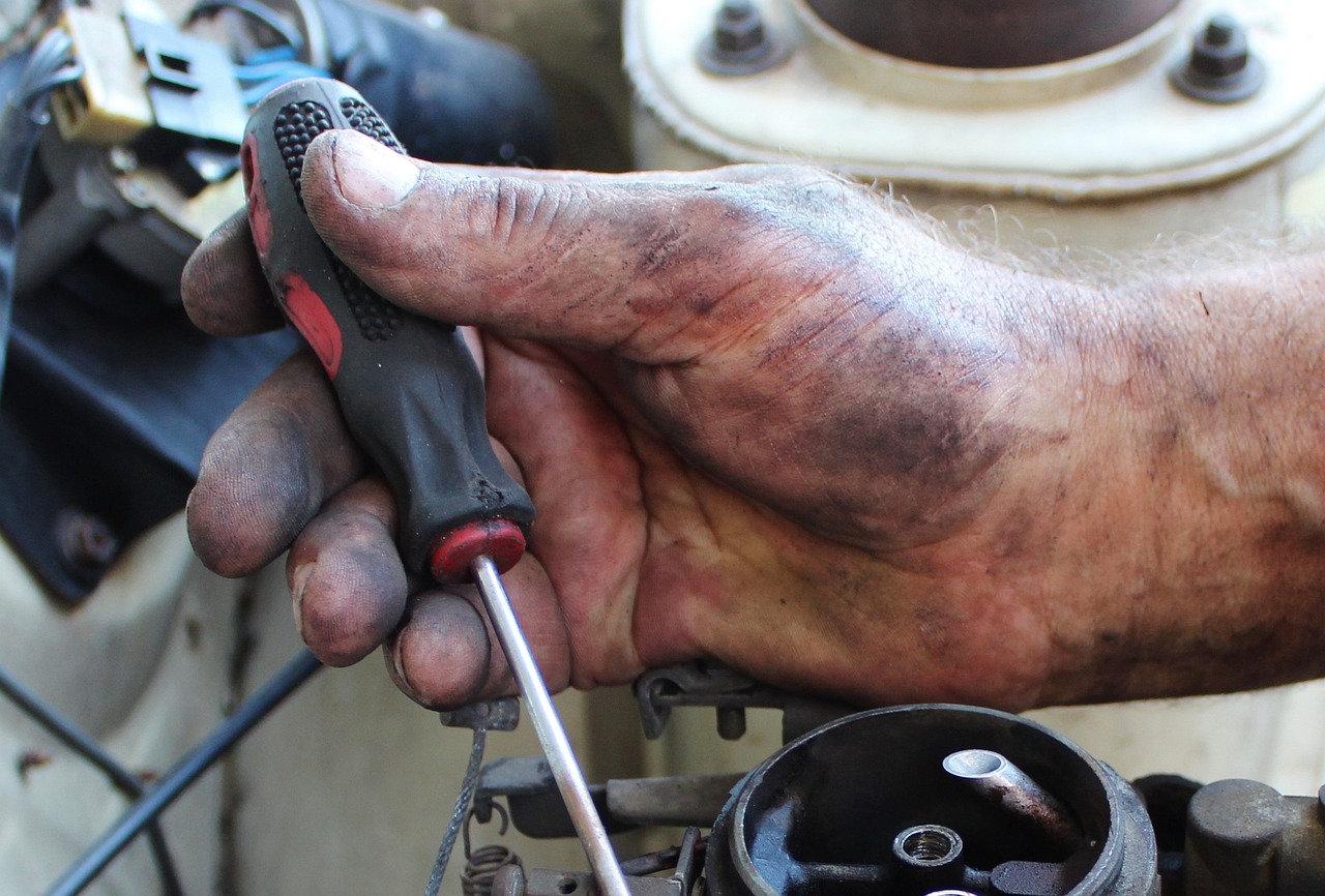 Closeup of aircraft mechanic's hand working on an engine