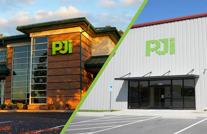 Exterior view of PJi buildings showing the companys brick headquarters and warehouse facility with PJi logos on both.