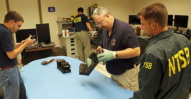 NTSB Agents Inspecting Black Boxes aka Flight Data Recorders after a Plane Crash