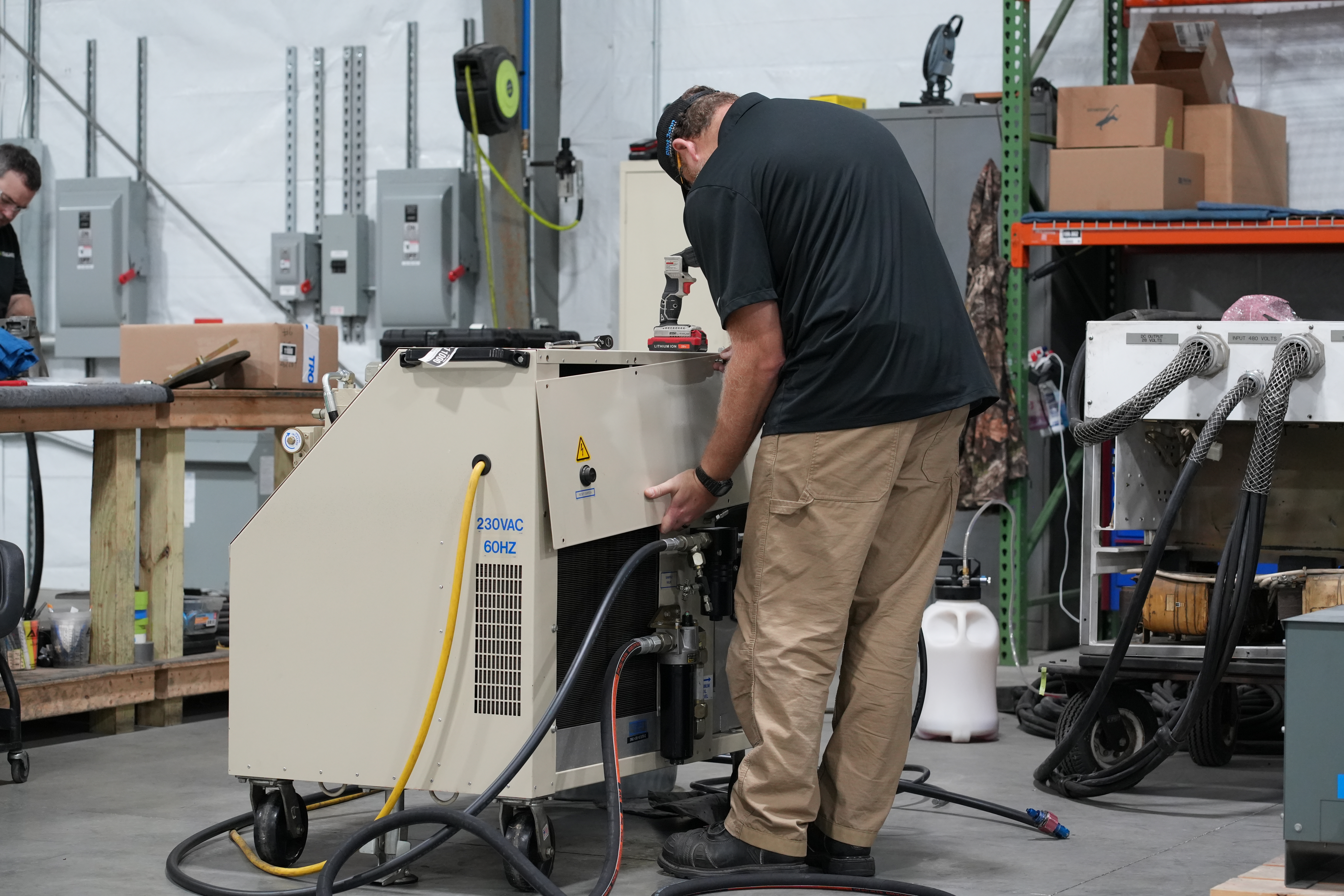 PJi Service Technician Removing Panel of a Hydraulic Power Unit (HPU)