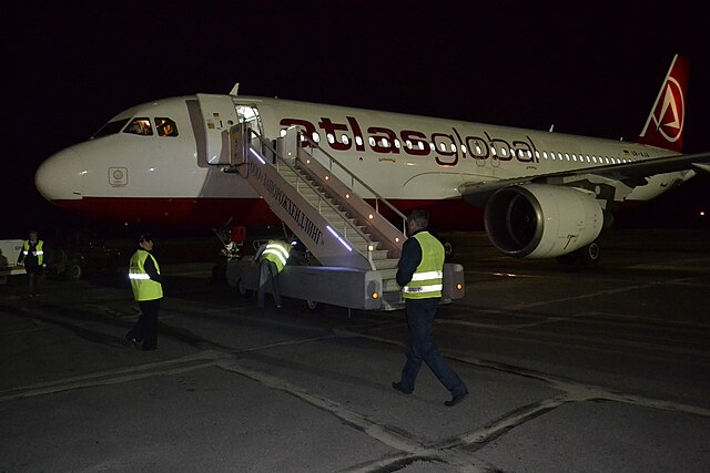 Ground Personnel in High-Visibility Safety Apparel at Night
