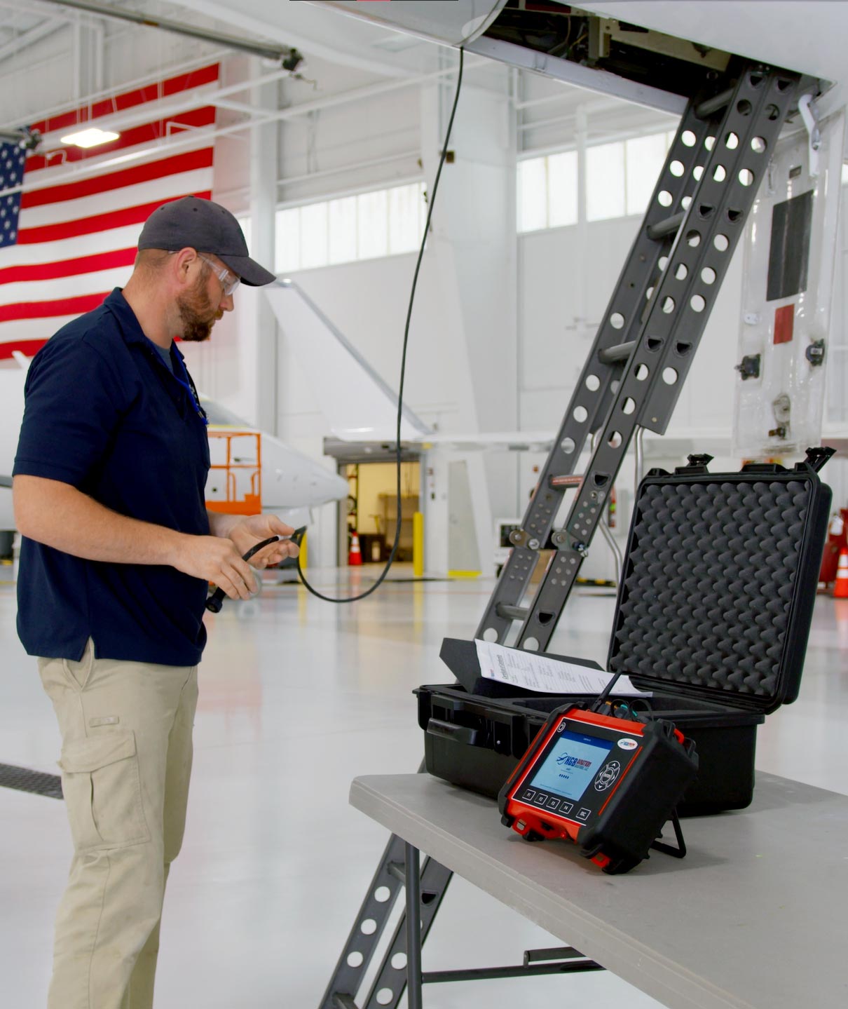 Technician connecting the DART to an aircraft flight data recorder