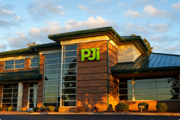 PJi corporate headquarters building with modern glass and brick exterior in Greenville, North Carolina