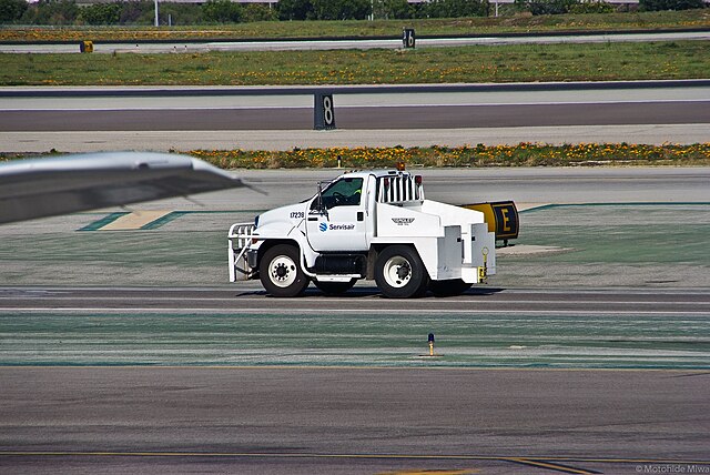 Eagle bobtail tractor driving across the tarmac at an airport