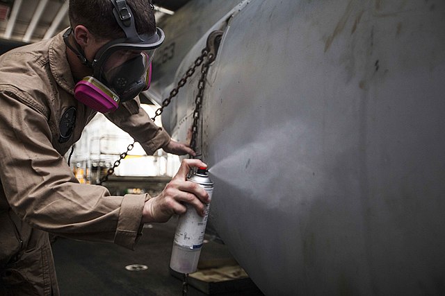 Aircraft Maintenance Technician Applying Anti-Corrosion Spray to an Aircraft